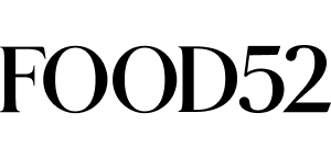 The image shows the logo for Food52, with the word FOOD52 in bold, black, uppercase serif letters on a light background.