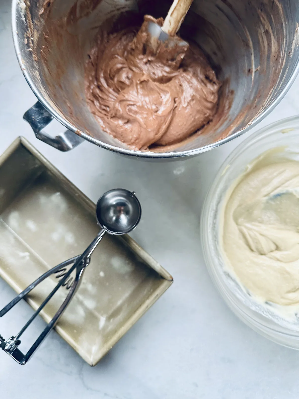 A bowl of brown liquid and a bowl of white and yellow liquid.