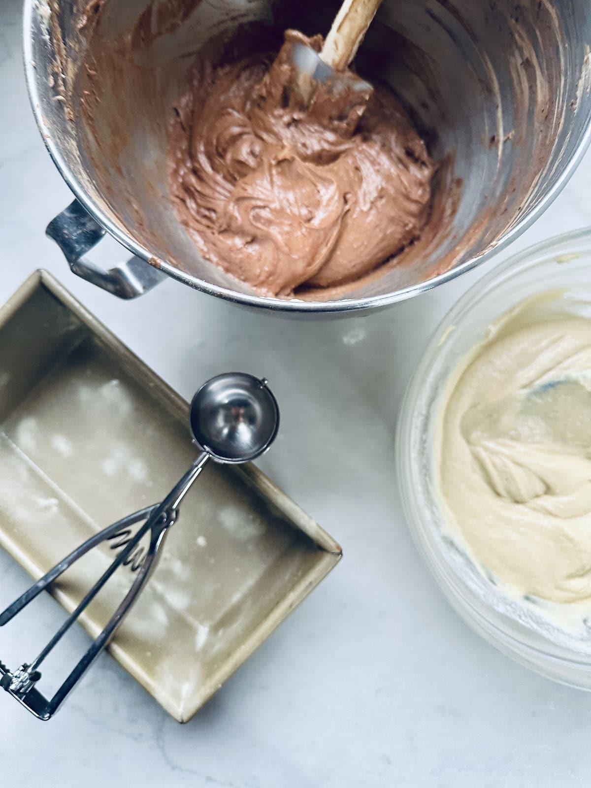 A bowl of brown liquid and a bowl of white and yellow liquid.